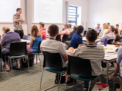 Photo of a MEI Conference session taking place in 2019