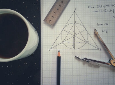 High Angle View Of Coffee Cup With School Supplies On Table